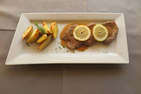 Veal Steak with Lemon Sauce, Fries and Salad