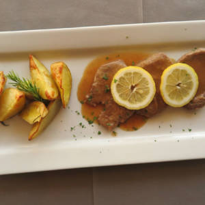 Veal Steak with Lemon Sauce, Fries and Salad